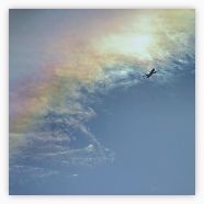 Plane with couloured clouds
